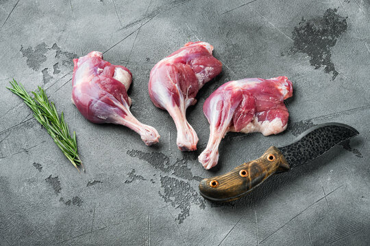 Duck leg thighs confit poultry meat raw Menu concept serving size, on gray stone background
