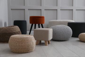Different stylish poufs and ottomans in room - obrazy, fototapety, plakaty