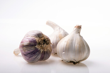 Fototapeta premium Garlic isolated on white background close up. Raw garlic with clove. Garlic bulb