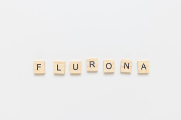 Word FLURONA on white background. COVID and flu double infection. First combination of two viruses...