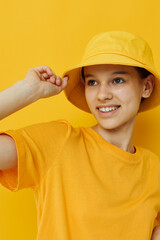 beautiful girl in a yellow t-shirt and Hat emotions summer style isolated background