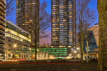 Fototapeta na wymiar Rotterdam, The Netherlands, January 6, 2022: downtown Willemsplein square, surrounded by offices, residential towers and parking garages, in the blue hour before sunrise