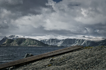 Snow covered mountains at West Cap in Norway .