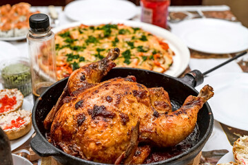 On the New Year's table there is a baked chicken and several delicious salads.