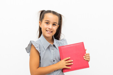 Obraz premium little girl isolated in white holding school book