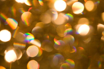 abstract, defocused, gold, white and rainbow sequin and spotlight bokeh background texture
