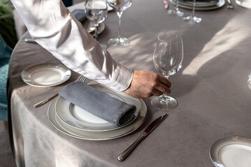 table serving with tablewear glasses and plates in restaurant. selected focus