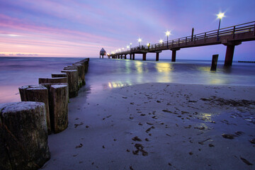 the pier in Zingst on the Baltic Sea, with a long exposure and purple pastel colors