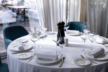 table serving with tablewear glasses and plates in restaurant. selected focus