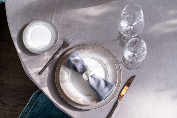 table serving with tablewear glasses and plates in restaurant. selected focus