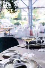 table serving with tablewear glasses and plates in restaurant. selected focus