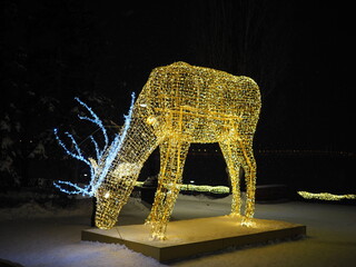 beautiful christmas glowing figures deer on a city street