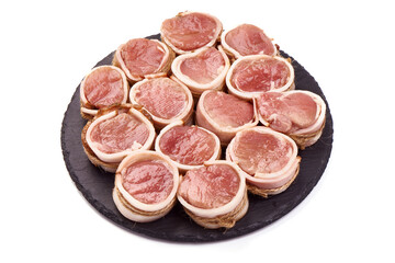 Pork medallions wrapped in bacon. Fresh raw pork tenderloin, isolated on white background.
