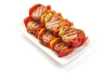 Grilled meat wrapped in bacon, pork medallions, close-up, isolated on white background.