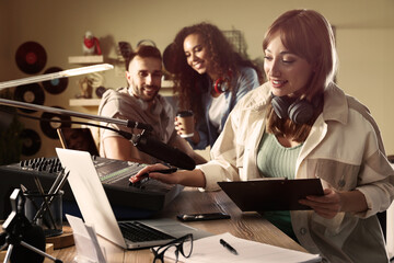 People working in modern radio studio with professional equipment