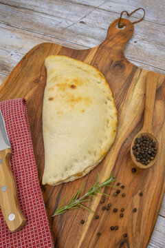 pizza calzone on a decorating board