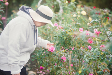 old woman relaxing in flower garden