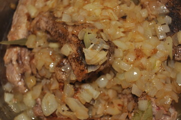 Fried pork ribs stewed in gravy with onion and spices. Delicious meat lunch dish.