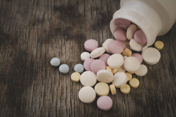 Painkillers on a wooden table background close