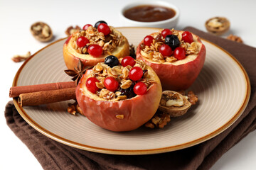 Concept of tasty food with baked apples on white background