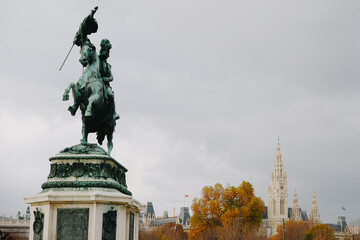 Equestrian Statue of Archduke Charles in Vienna ( Austria ) with the town hall ( Rathaus ) at the...