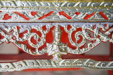 An old red and golden altar table before recovery.