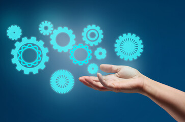 gear wheels and female hand on a blue background. Business structure precise work concept, team...