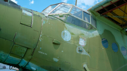 Close up of old military transport aircraft at the open-air exhibition in summer