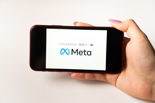 META logo on smartphone being held in hand in front of phone with Facebook icon. Facebook changes company name to Meta and focuses on Metaverse in its rebrand. Los Angeles, California, USA - January 5
