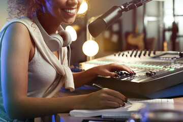 African American woman working as radio host in modern studio, closeup