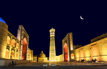Fototapeta na wymiar View on ensemble Poi Kalyan, consists of the Kalyan minaret, the Kalyan mosque and the Miri-Arab madrasah at moon night. Bukhara, Uzbekistan,