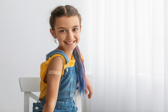 Happy Vaccinated Teen Girl Showing Shoulder After Inoculation