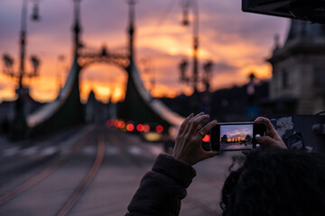 Tourist photographing liberty bridge of Budapest
