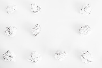 overhead shot of crumpled paper in oder and copy space in the middle on white background. great idea concept