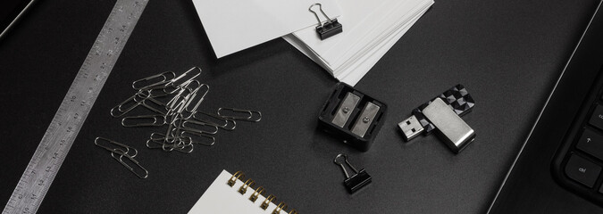 Workspace. Office black desk with stationery. Dark background. Flat lay