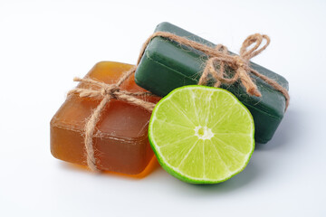 Handmade soap with lime on a white background.