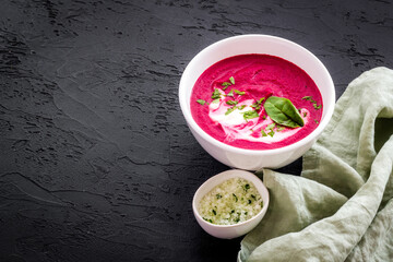 Red vegetarian beet root cream soup with herbal basil salt