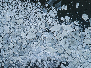 Aerial drone view on ice floes on ocean surface in Norways arctic sea
