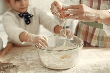 Family cook the dough for cookies