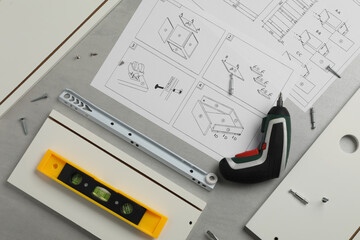 Flat lay composition with furniture parts and tools for self-assembly on grey background