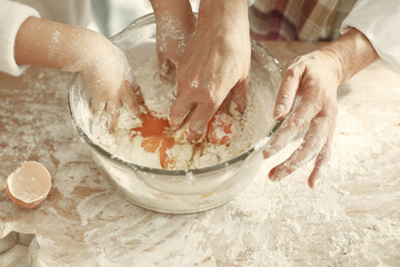 Family cook the dough for cookies