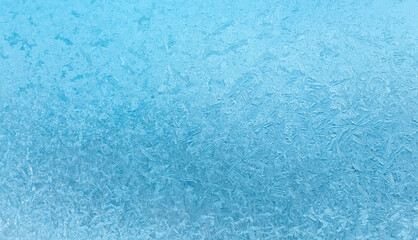 Abstract winter background. Frosty ice patterns on the window
