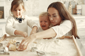 Family cook the dough for cookies