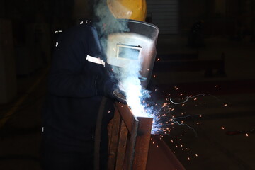 The man welding in the factory