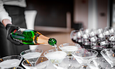 waiter pouring champagne wine from bottle in glasses © pavel siamionov
