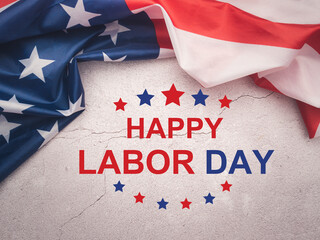Happy labor day text over a cement floor background and American Flag