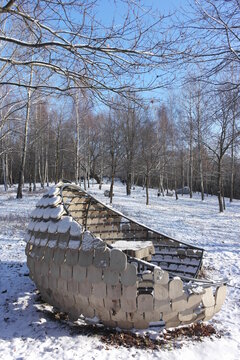 Forest park "musical glade" with interesting design wooden empty pavillion gazebo bench. Woodland in Krakow covered with fresh clean snow. Frosty winter environment tranquility atmosphere. Poland