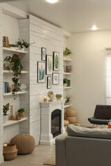 Stylish living room interior with decorative fireplace