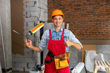 Young male worker or builder in building being renovated
