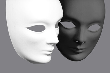 Two plaster Venetian masks on a gray background